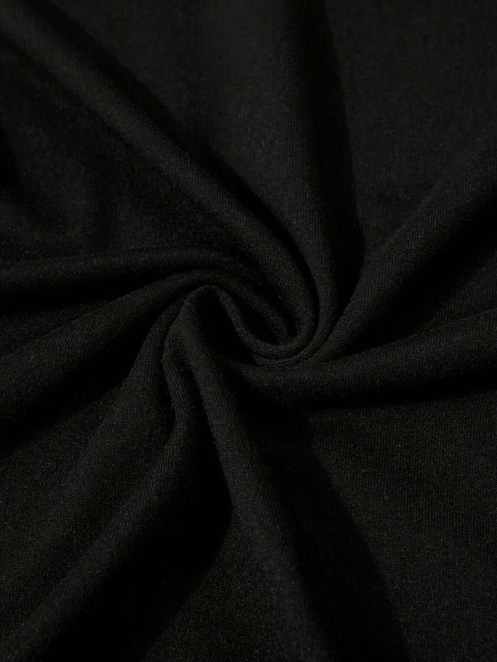 Close-up of soft black polyester fabric showcasing smooth texture, ideal for women's graphic tees.