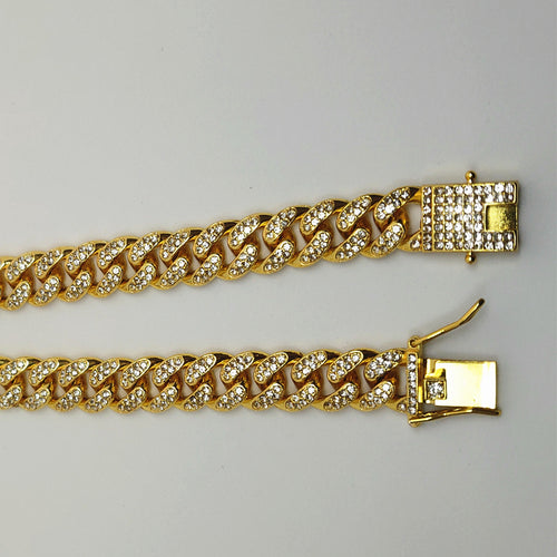 Cuban chain diamond bracelet showcased with shiny gold alloy and sparkling diamond inlay.