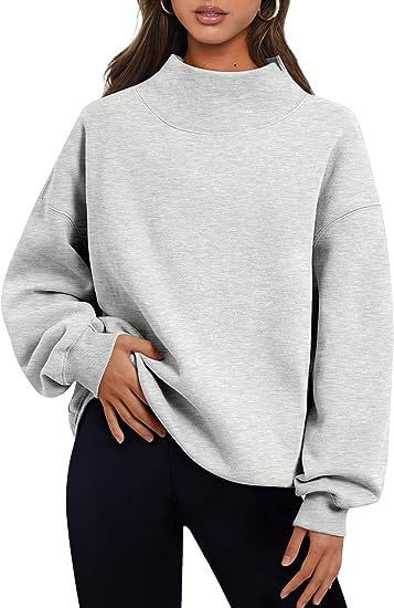 Solid color women's pullover hoodie in light gray, featuring a round neck and loose oversized fit.